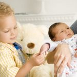 A mother and her son with a new baby A mother and her son with a new baby