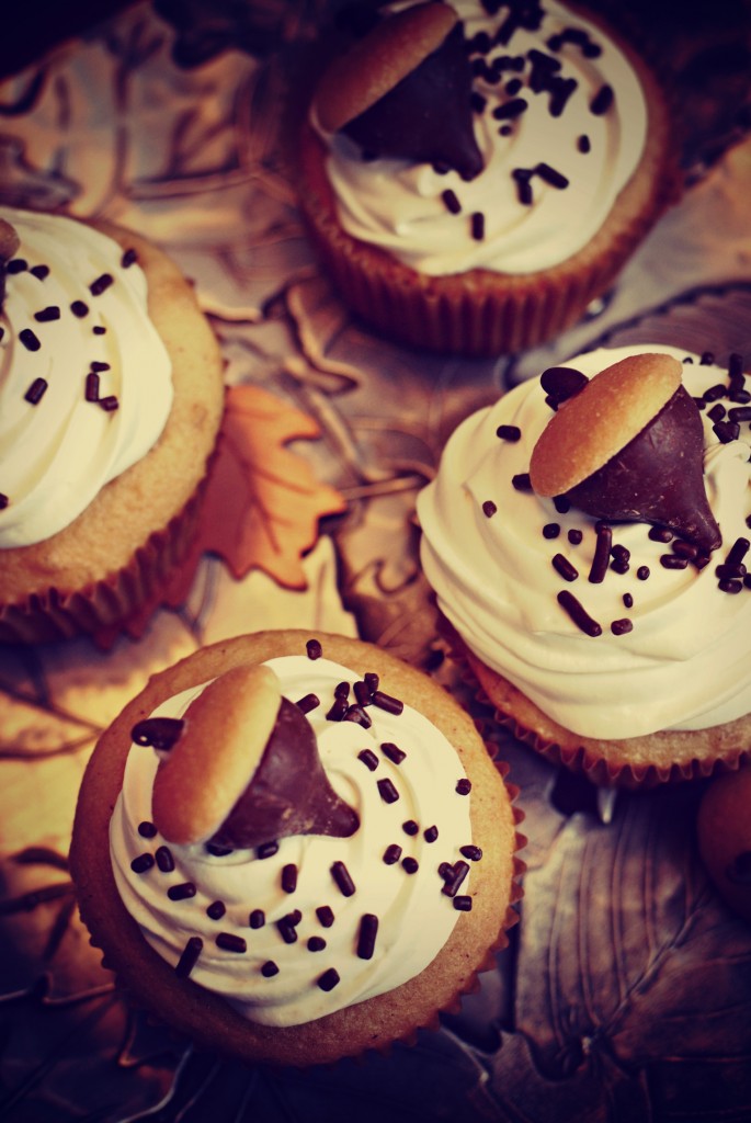 finished snickerdoodle cupcake recipe with candy acorns on top laying on a platter