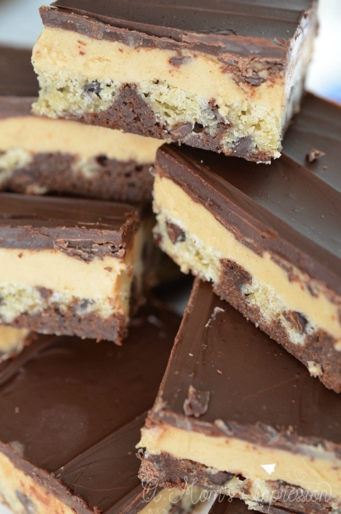 peanut butter chocolate bars piled on a plate for dessert