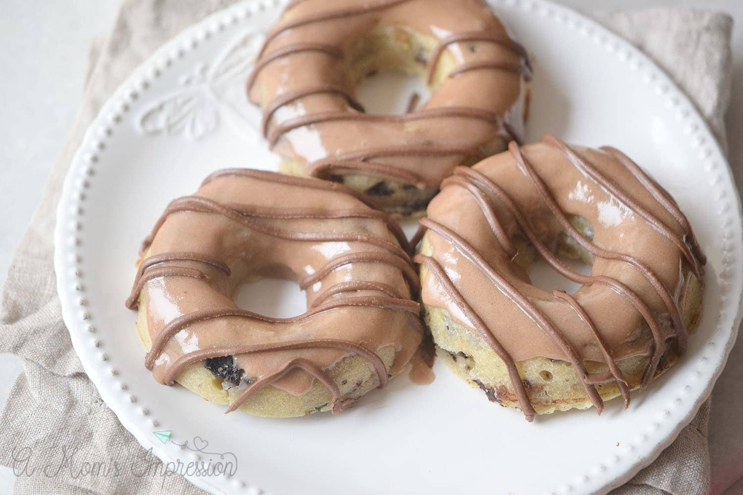 This recipe for simple and delicious Baked Chocolate Chip Donuts will convert you from the fried version. So easy and tasty everyone will love them. 