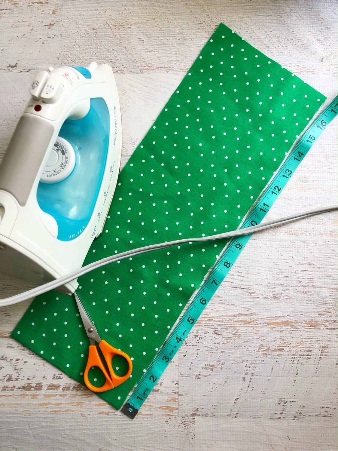 Green Fabric being ironed to hang the shamrock wreath with. 