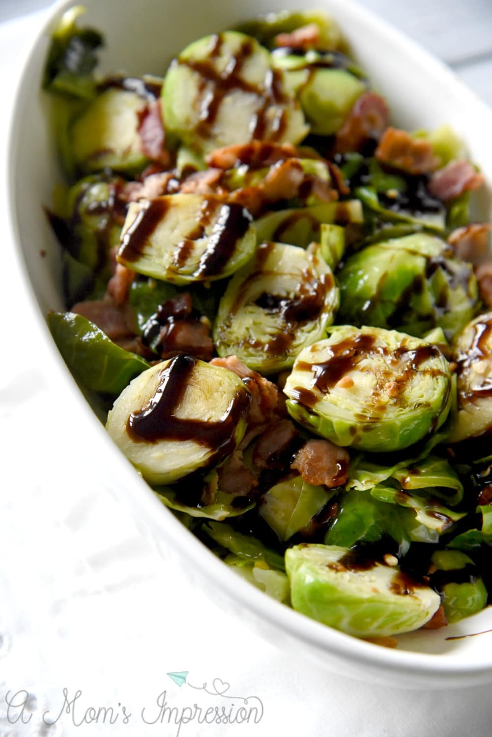 Bacon and Balsamic Brussels Sprouts in a white serving bowl 