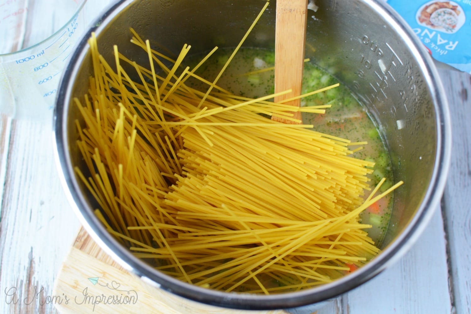 noodles being added to the crack chicken noodle soup