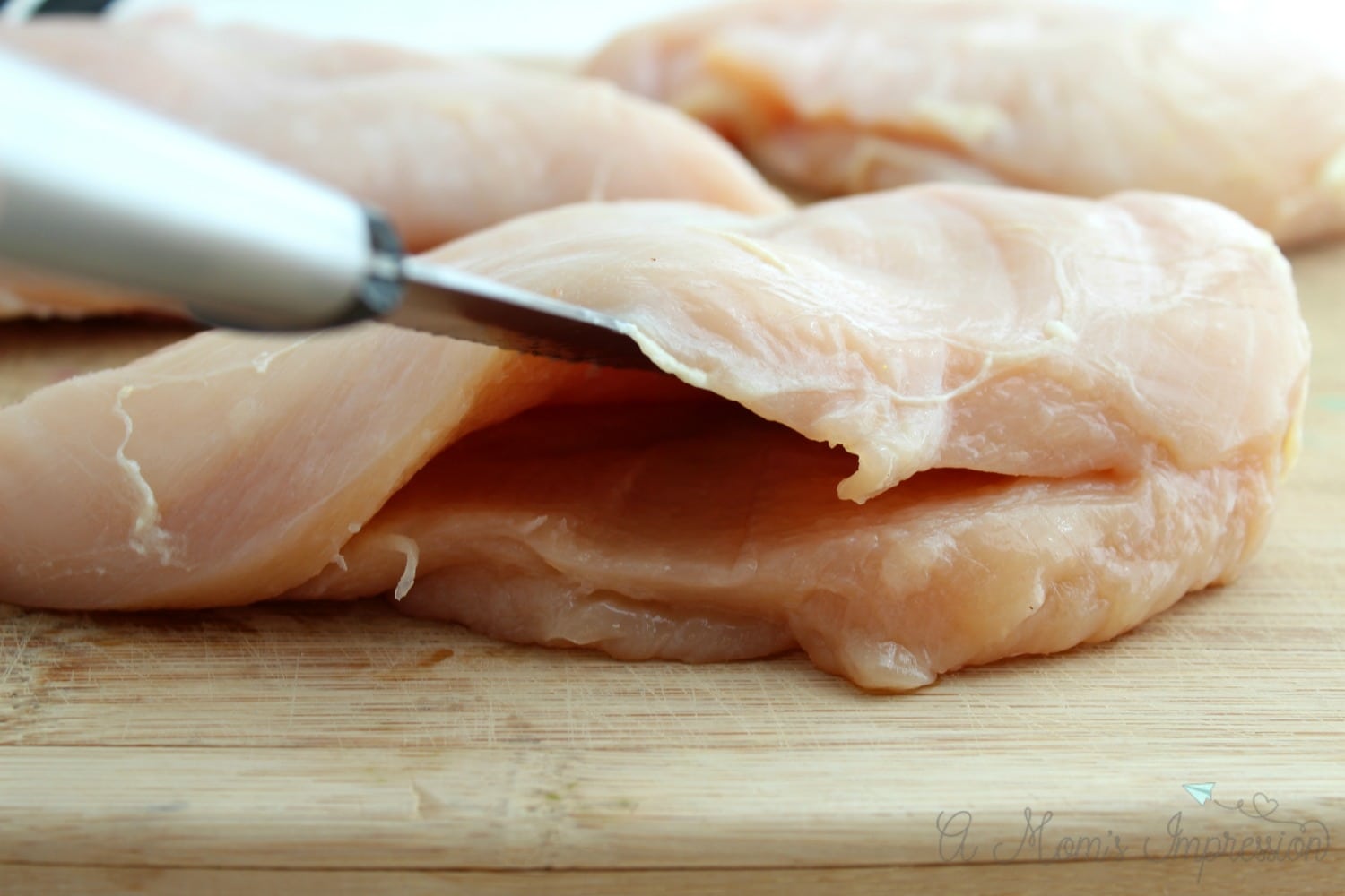 Using the knife to help stuff chicken breasts.
