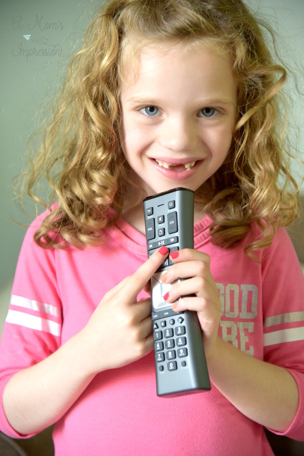 child holding a Xfinity remote