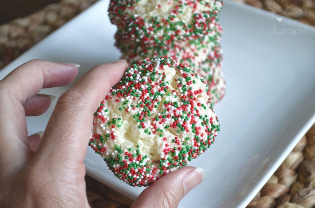 a person holding a christmas cookie