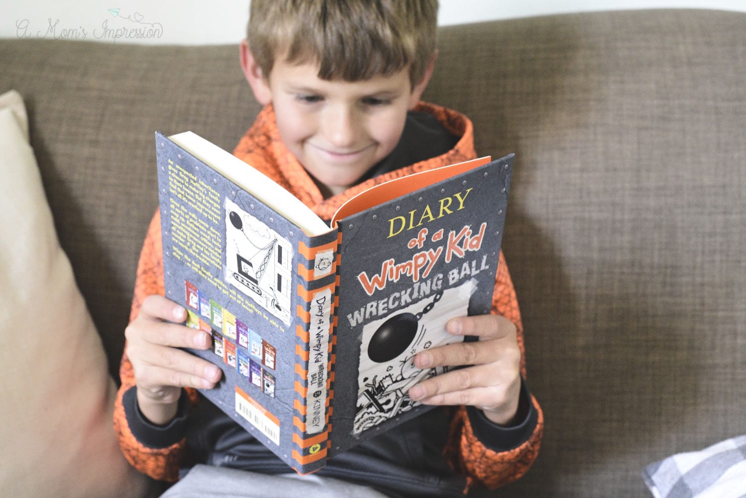 a boy reading Diary of a Wimpy kid