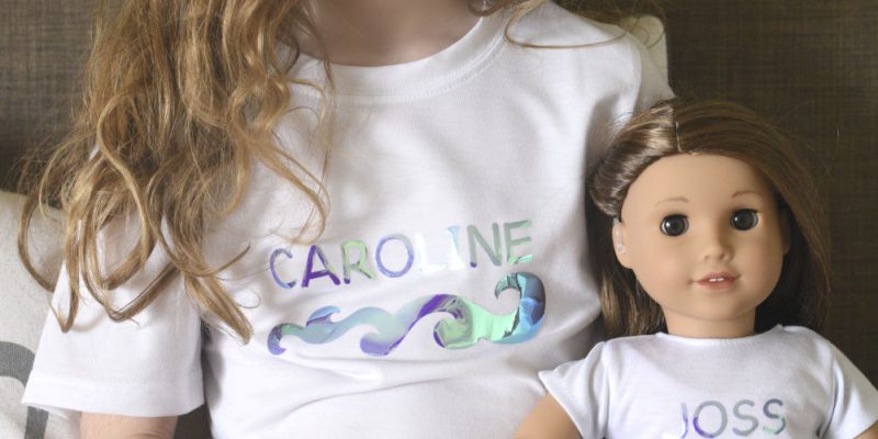a girl wearing matching shirts with her doll, Joss