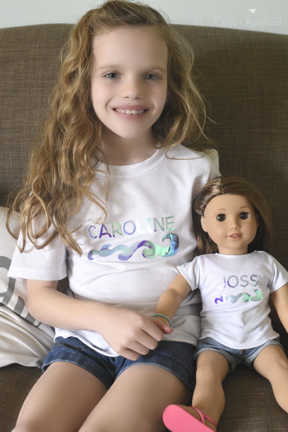 a girl wearing matching shirts with her doll, Joss