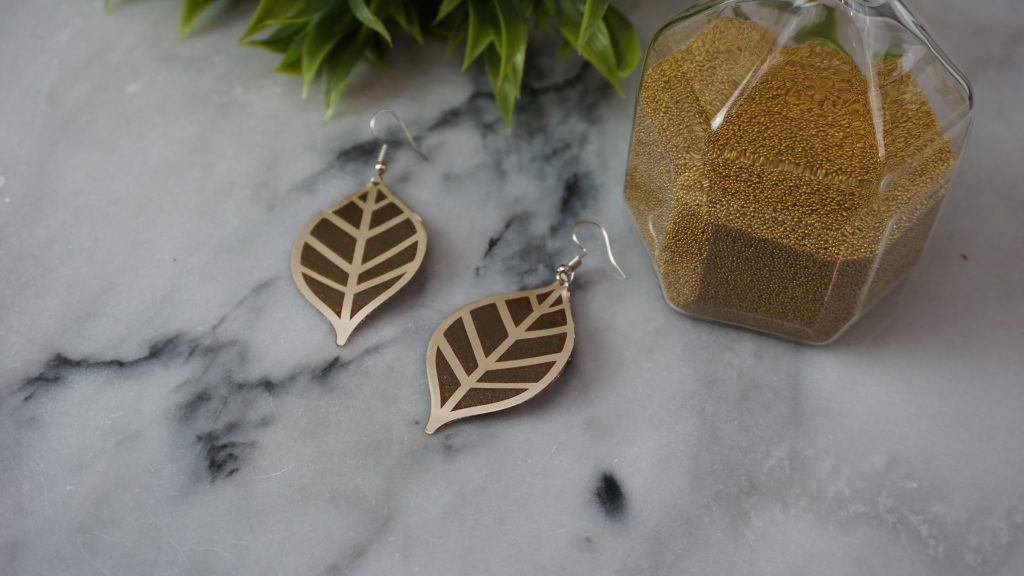 Cricut earrings laying on a table