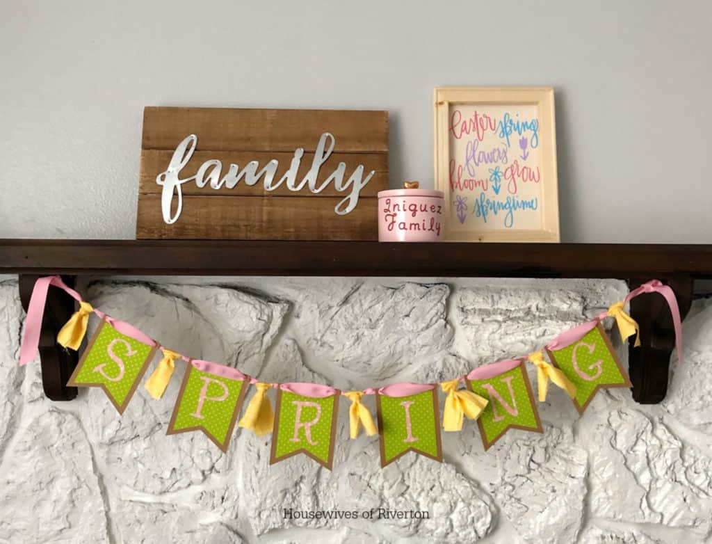 a custom spring sign sitting on a ledge on top of a fireplace