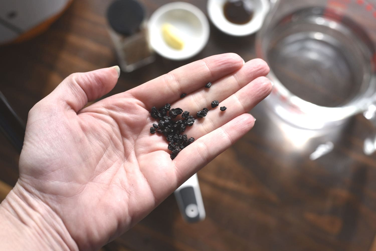 a open hand with some dried elderberries in it