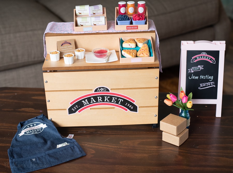 A city market play toy with stand, flowers and a doll apron