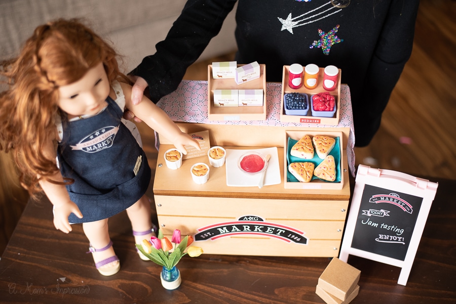 A close up view of the City Market with a doll and girl playing with her