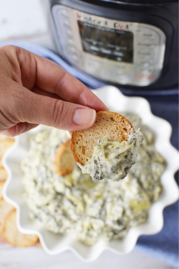 Spinach Artichoke Dip being served with bread. 