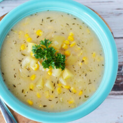 Instant Pot Corn Chowder being served in a blue bowl for dinner.