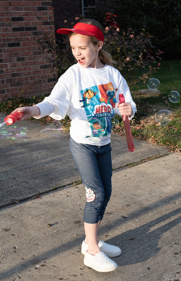 A girl blowing big bubbles 