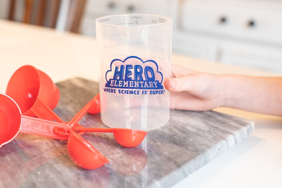 a cup and some measuring spoons with Hero Elementary written on them