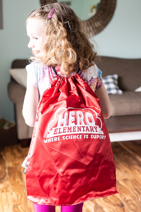 a girl wearing a back pack with Hero Elementary on it 