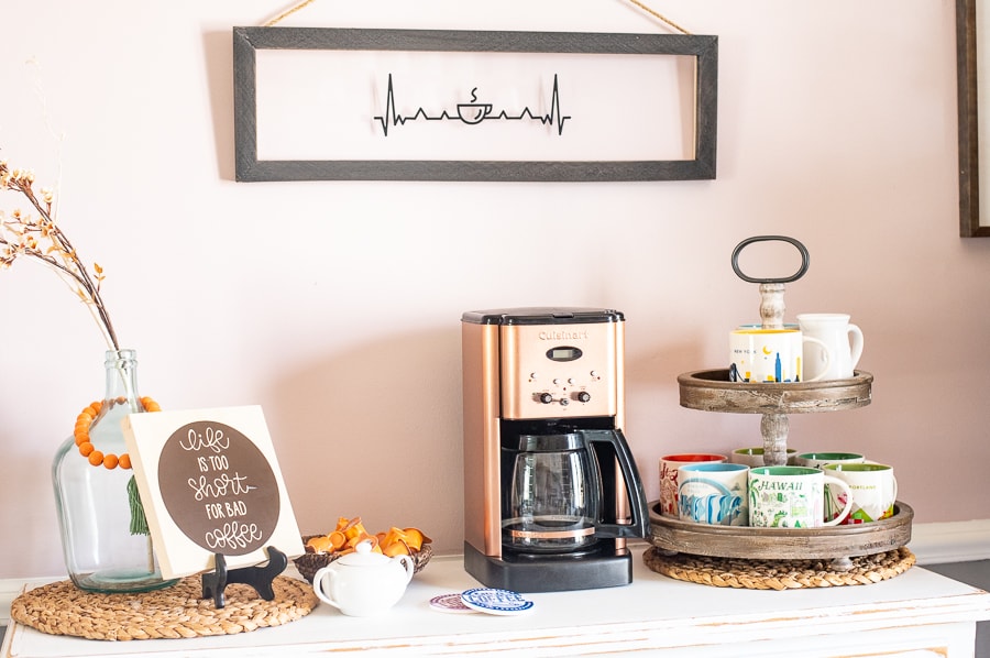 A custom coffee bar set up with coffee mugs, a coffee machine and custom signs