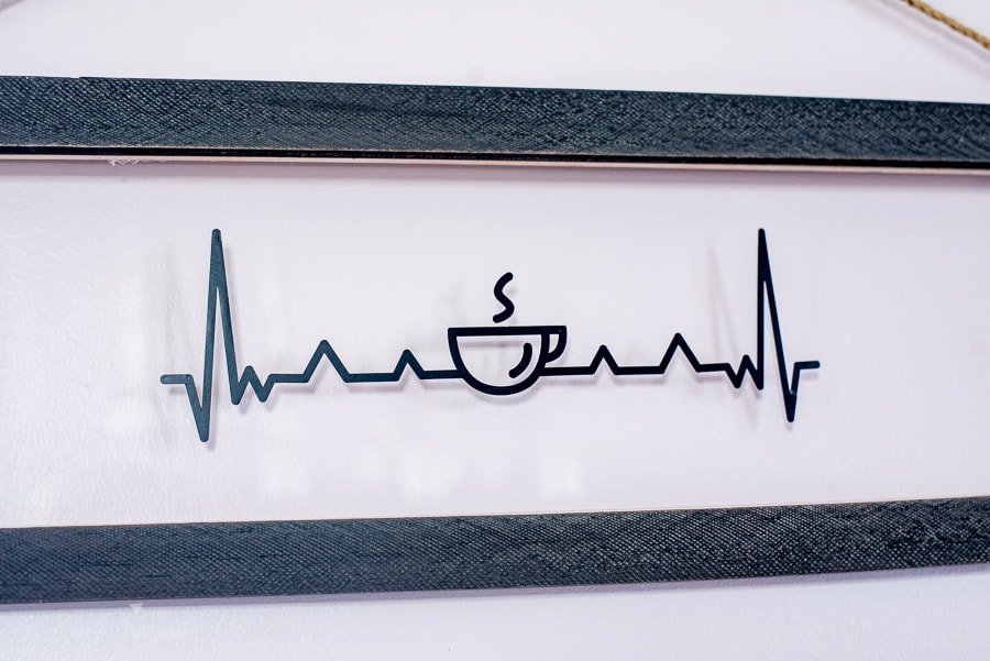 a heart beat sign with a coffee cup in the middle