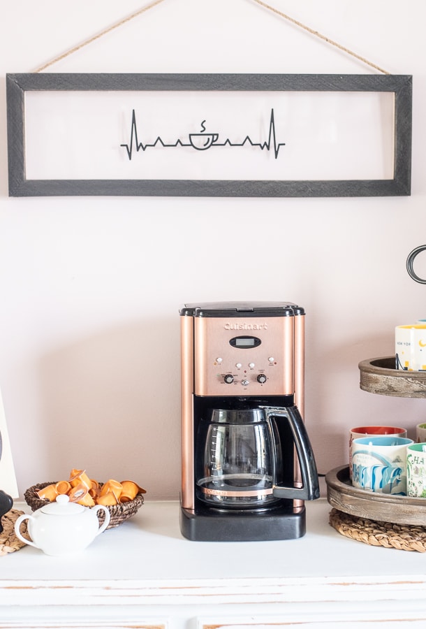 A custom coffee bar set up with coffee mugs, a coffe machine and custom signs