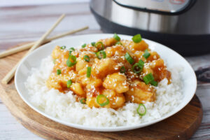 Instant Pot General Tso's Chicken being served over white rice.