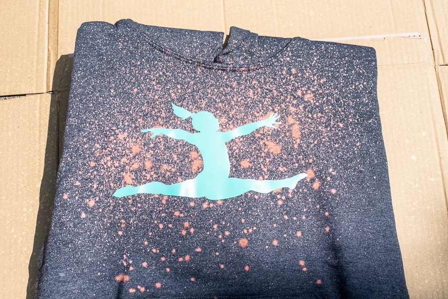 a gymnast decal on a hoodie being bleached