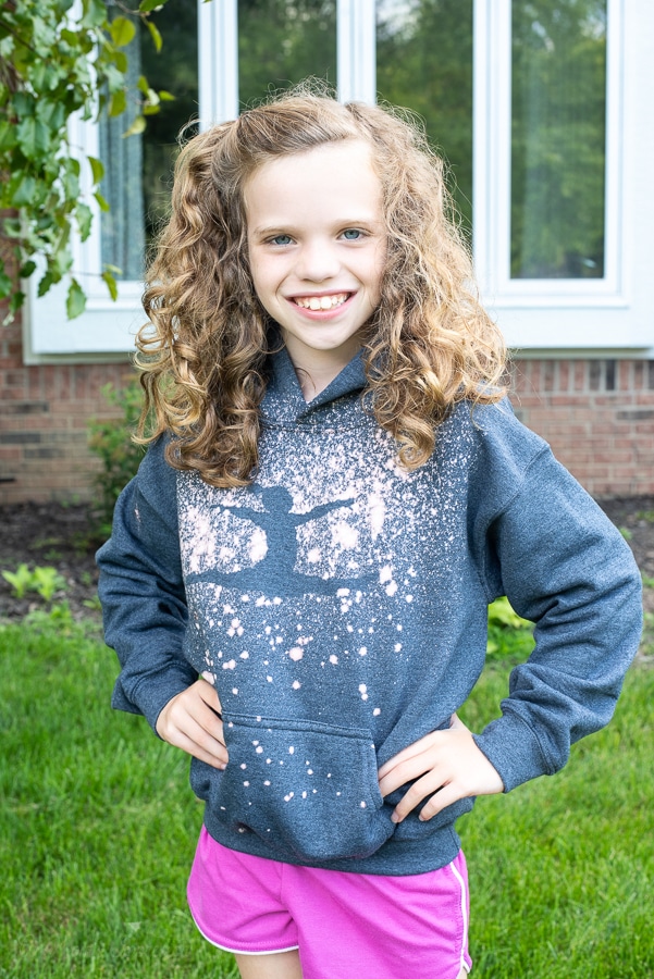 a girl wearing a gymnast hoodie