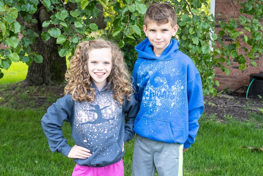 Two kids wearing custom hoodies with a bleached design on them