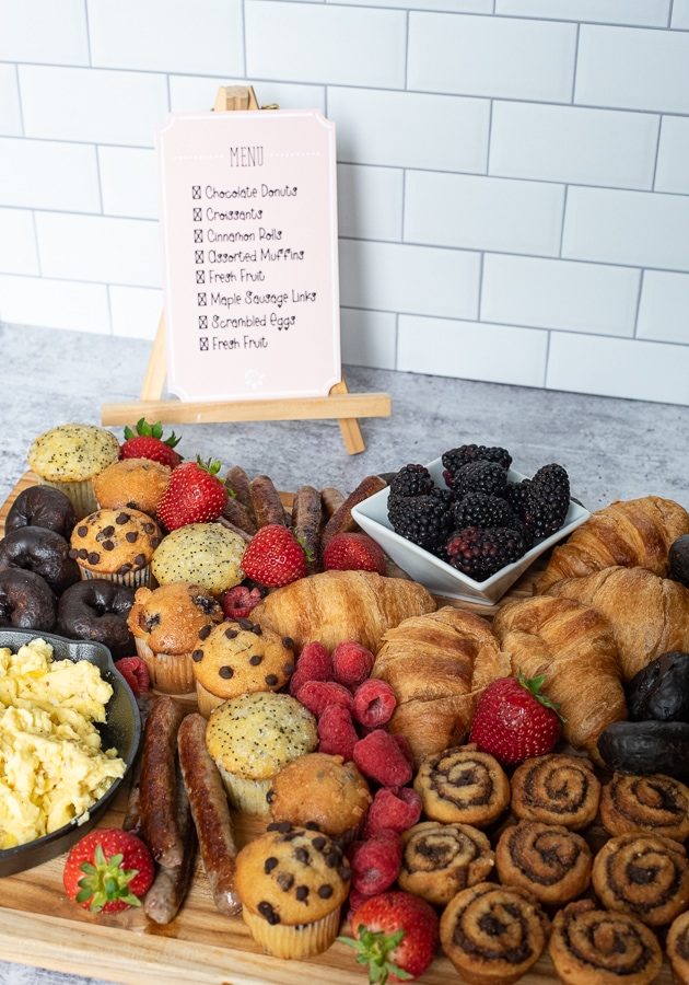 a spread of breakfast items with a menu in the background