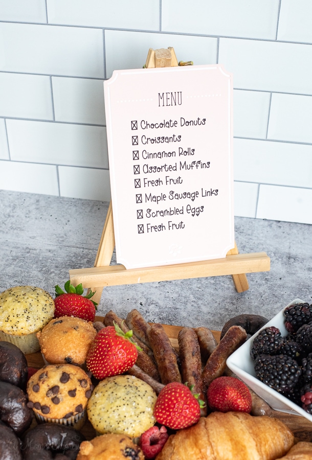 a menu being displayed behind a charcuterie board