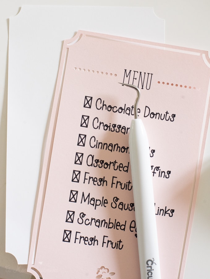 a weeding tool on top of a custom breakfast menu