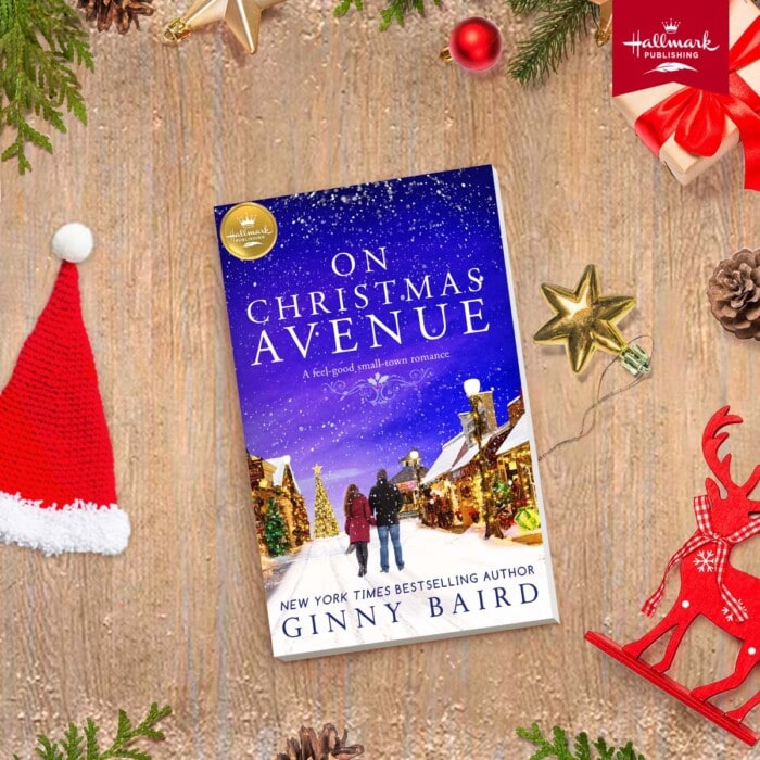 The book "On Christmas Avenue" surrounded by holiday decor