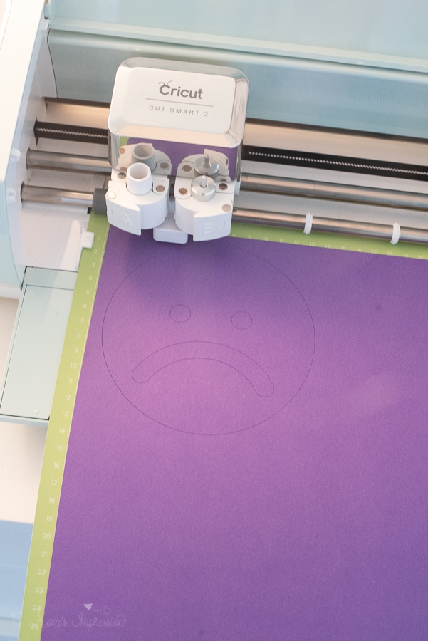 a cricut cutting machine making emotion signs