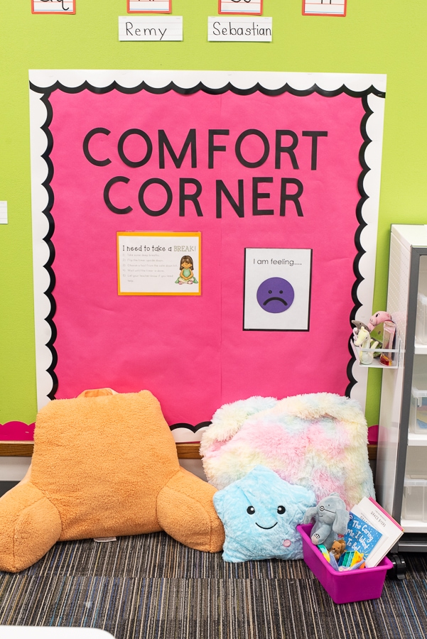 a comfort corner in a classroom with pillows and books