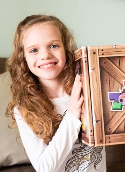 Young girl holding activity box.